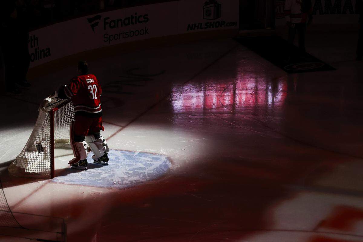 Brandon Bussi of the Carolina Hurricanes in net during the first period against the Calgary Flames at Lenovo Center on November 30, 2025 in Raleigh, North Carolina.