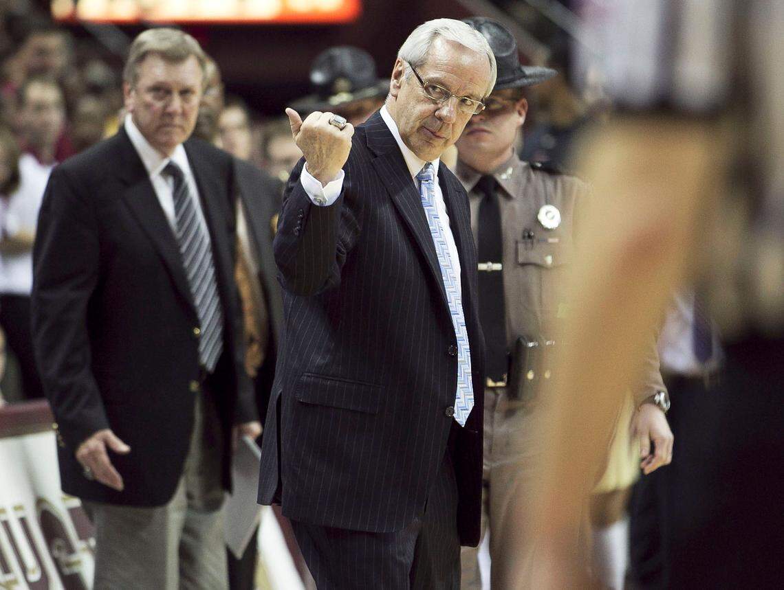 UNC coach Roy Williams directs his players to leave the court with 14.1 seconds to play against Florida State. Williams said he did it for the safely of his team, knowing that the Florida State fans would storm the court.