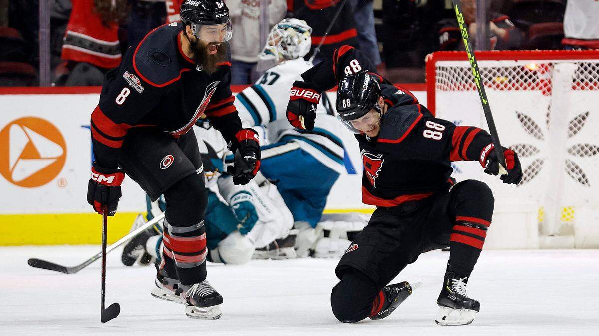 Carolina Hurricanes’ Martin Necas (88) celebrates his tying goal against the San Jose Sharks with Brent Burns (8) during the third period of an NHL hockey game in Raleigh, N.C., Friday, Jan. 27, 2023. (AP Photo/Karl B DeBlaker)