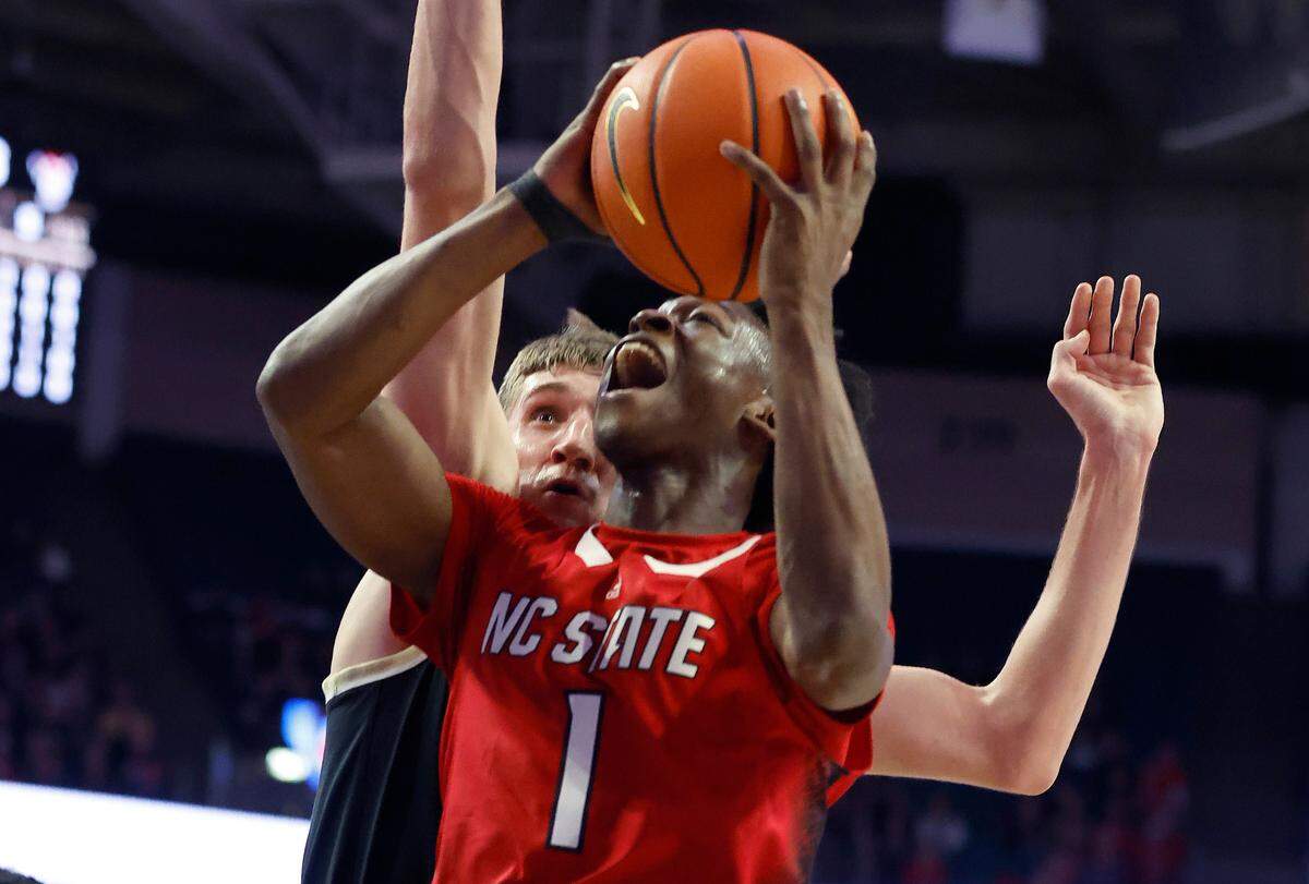 N.C. State’s Jarkel Joiner (1) shoots as Wake Forest’s Andrew Carr (11) defends during the first half of N.C. State’s game against Wake Forest at Joel Coliseum in Winston-Salem, N.C., Saturday, Jan. 28, 2023.