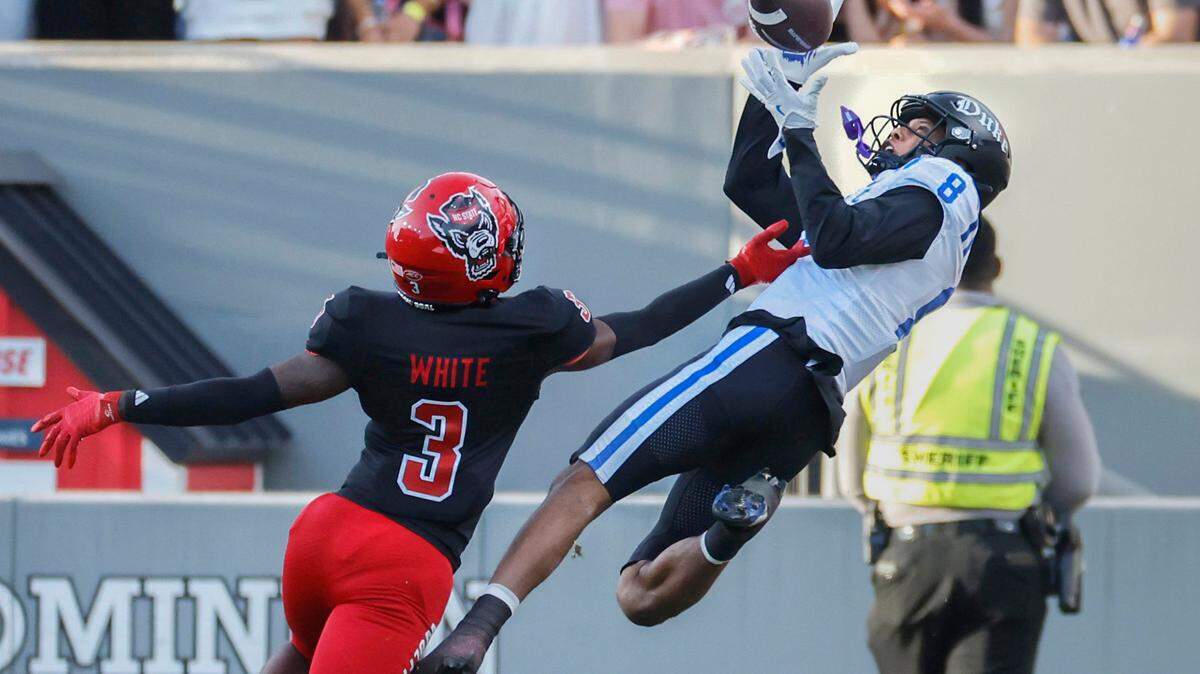 Duke wide receiver Jordan Moore pulls in a 45-yard TD catch as N.C. State cornerback Aydan White defends during the first half of N.C. State’s game against Duke at Carter-Finley Stadium in Raleigh, N.C., Sat. Nov. 9, 2024.
