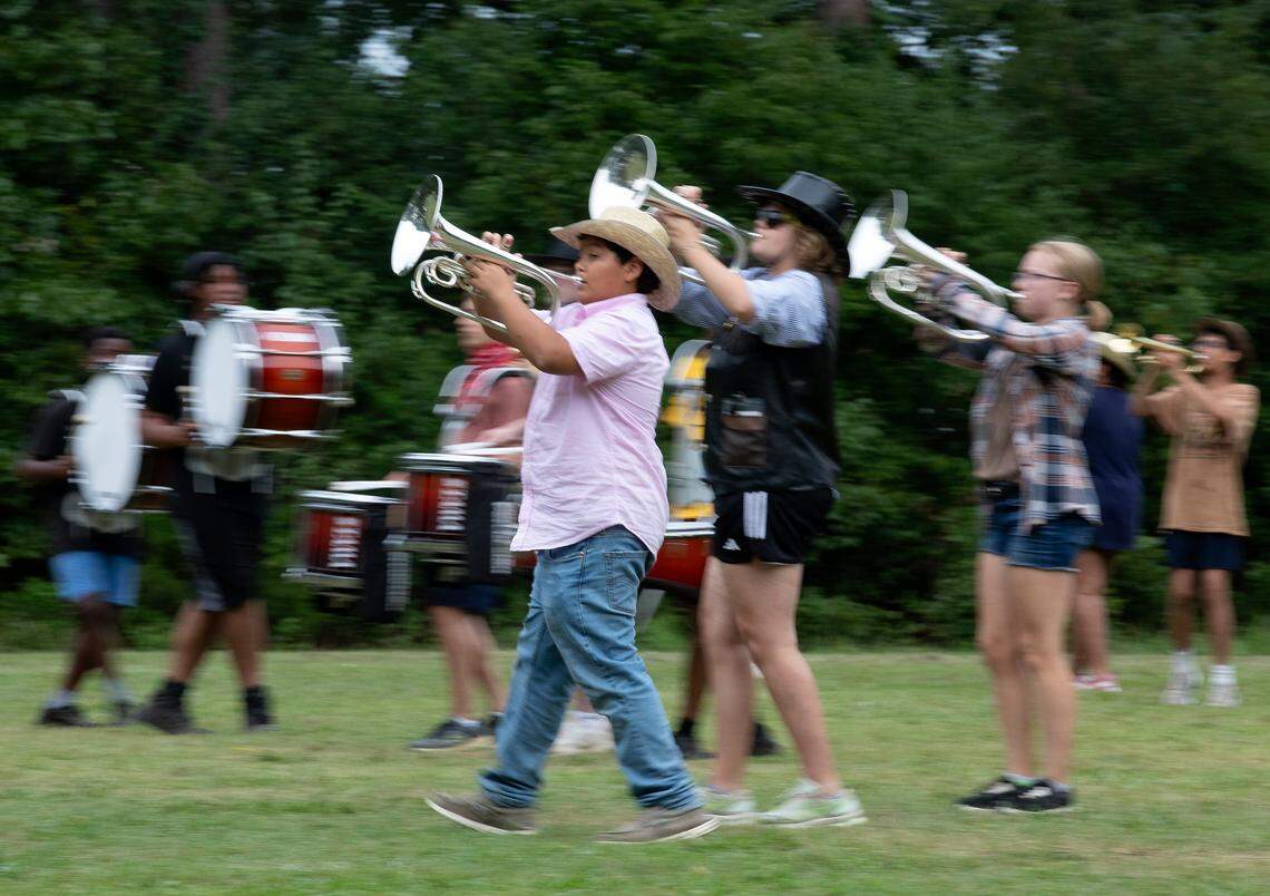 Freshman mellophone player Will Anorve, center, marches during a performance for parents and families on the final day of marching band camp at Jordan High School on Friday, August 2, 2024, in Durham, N.C.