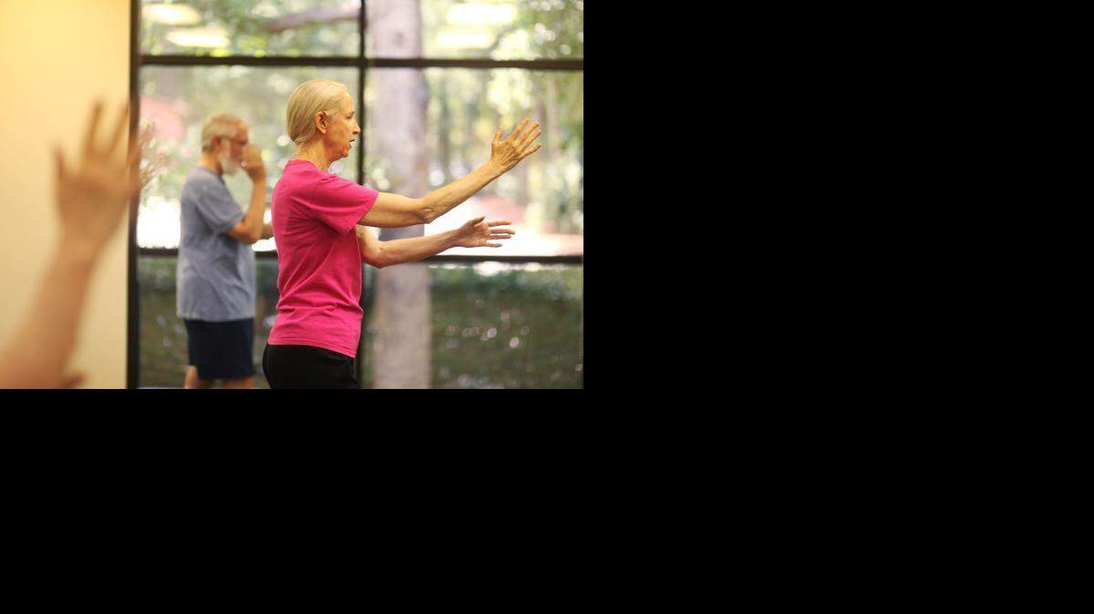 From left, Ed Tremblay follows tai chi instructor Norma Ferrell in a weekly tai chi class Ferrell teaches at Rex Wellness Center in Raleigh on Wednesday, August 20, 2014.
