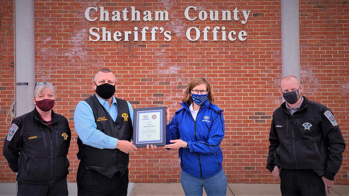 Chatham County Sheriff Mike Roberson receives the 2020 Humane Law Enforcement Award by The Humane Society of the United States “for his leadership in combating illegal animal abuse” from North Carolina State Director for the Humane Society Gail Thomssen. Animal Resources Director Karen Rogers, is left, and Animal Resources Lieutenant Stephen Renn, right.