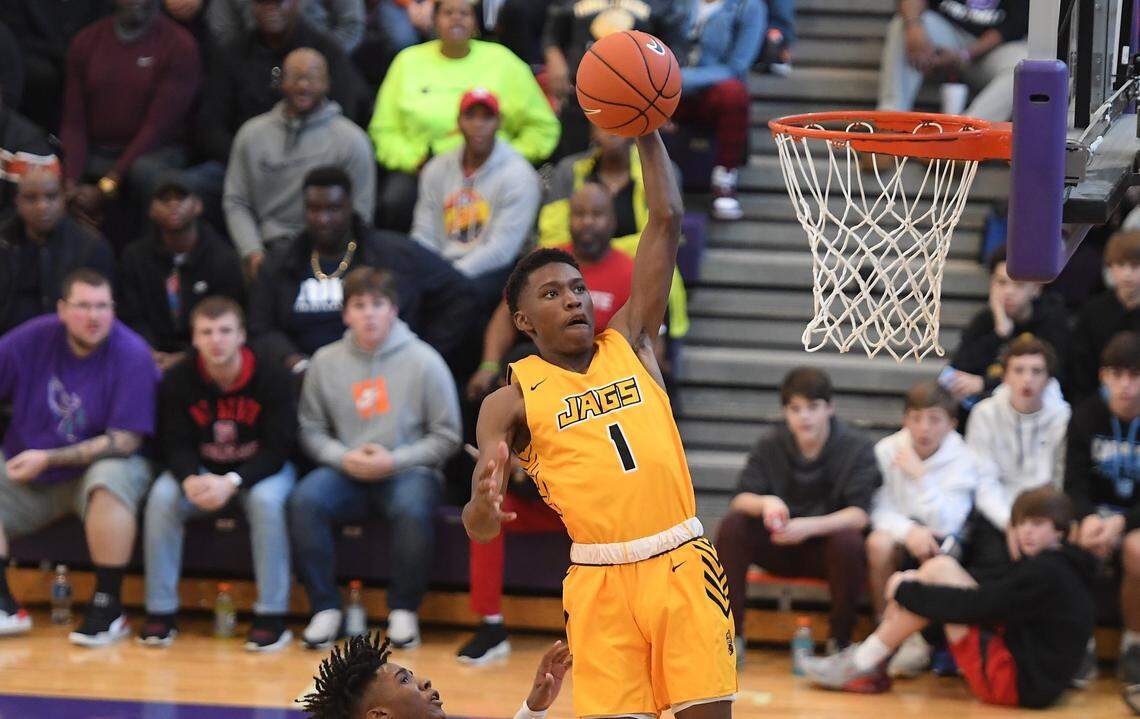 Terquavion Smith (1) of Farmville Central dunks for two points against Naikeed Thomas, left, of Broughton. The Farmville Central Jaguars played the Broughton Capitals in a boys basketball game that was part of the John Wall Holiday Invitational on December 26, 2019.