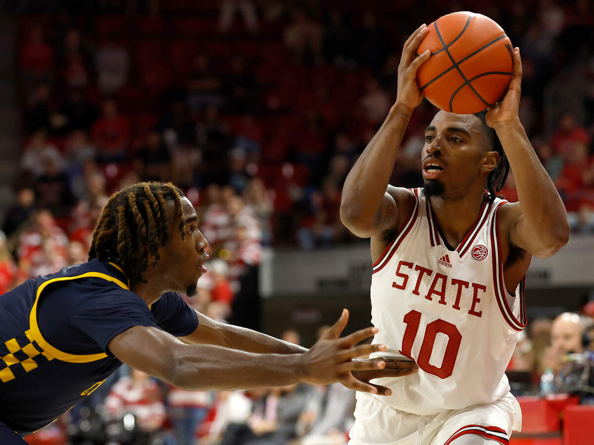 N.C. State’s Marcus Hill looks to pass around the defense during the second half of the Wolfpack’s 66-56 win over Coppin State on Tuesday, Dec. 10, 2024, at Reynolds Coliseum in Raleigh, N.C.
