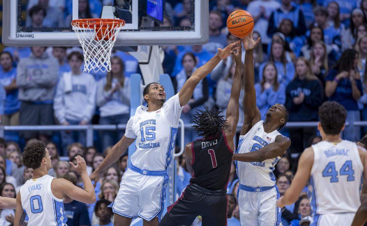 North Carolina forwards Jarin Stevenson (15) and Caleb Wilson (8) defend N.C. Central guard Kyric Davis (1) in the first half on Friday, November 14, 2025 at the Smith Center in Chapel Hill, N.C.