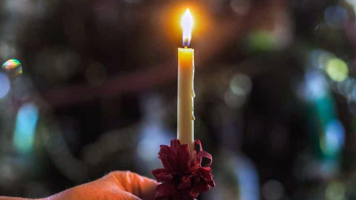 Near the end of a Moravian Lovefeast service at Christmas, congregants pass the light of Christ, symbolized by the lighting of a beeswax candle. As a result of the pandemic, some churches modified their services, moving them outdoors or creating to-go kits for celebrating at home.