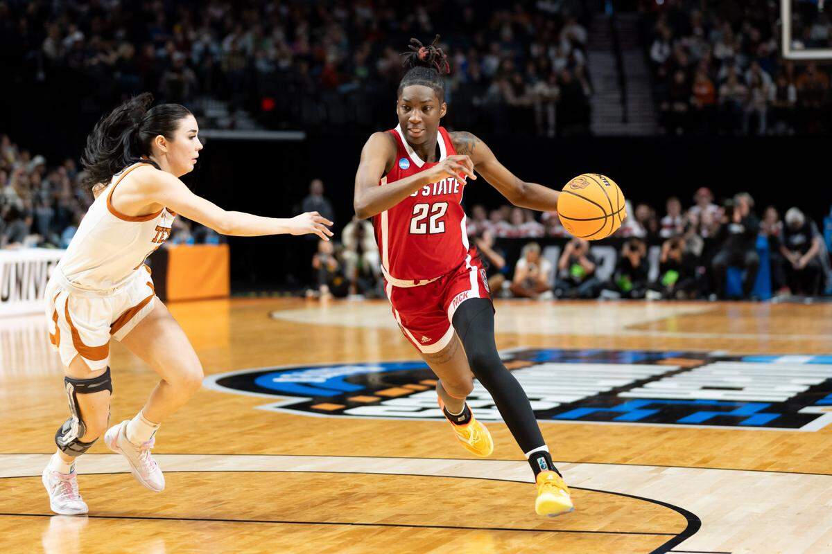 NC State’s Saniya Rivers drives against a Texas defenders during their NCAA Tournament Elite 8 game in Portland, Sunday, March 31, 2024.