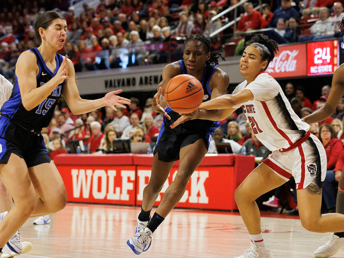 Duke’s Emma Koabel and Jadyn Donovan battle N.C. State’s Madison Hayes for a loose ball during the first half of the Wolfpack’s 72-57 win on Sunday, Jan. 21, 2024, at Reynolds Coliseum in Raleigh, N.C.