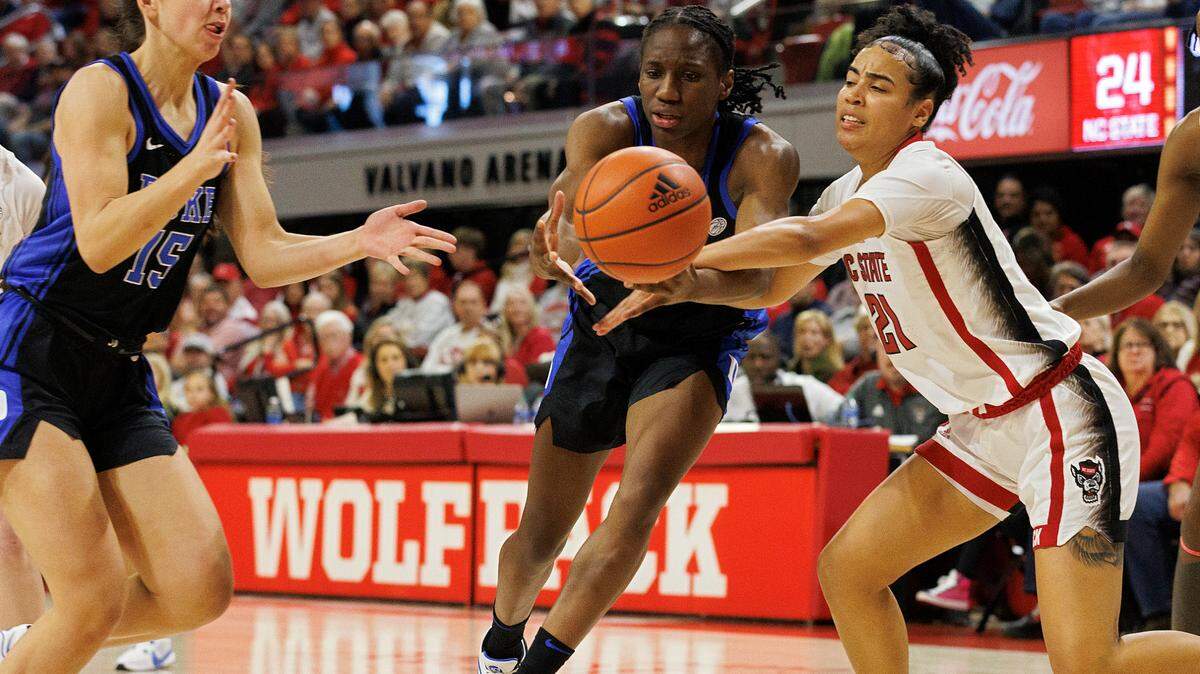 Duke’s Emma Koabel and Jadyn Donovan battle N.C. State’s Madison Hayes for a loose ball during the first half of the Wolfpack’s 72-57 win on Sunday, Jan. 21, 2024, at Reynolds Coliseum in Raleigh, N.C.