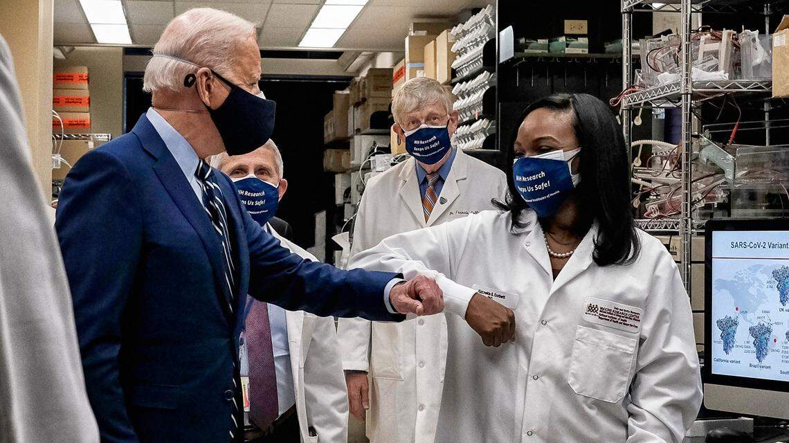 President Joe Biden bumps elbows with Dr. Kizzmekia Corbett as he visits the Viral Pathogenesis Laboratory at the National Institutes of Health in Bethesda, Md., Feb. 11, 2021.