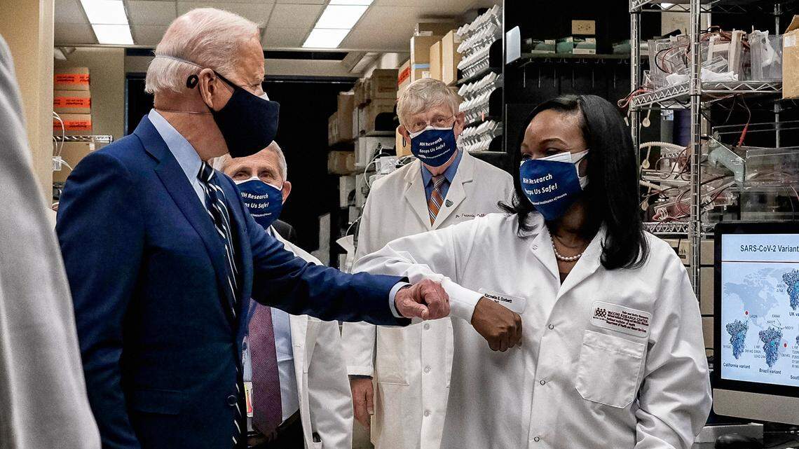 President Joe Biden bumps elbows with Dr. Kizzmekia Corbett as he visits the Viral Pathogenesis Laboratory at the National Institutes of Health in Bethesda, Maryland, Feb. 11, 2021.