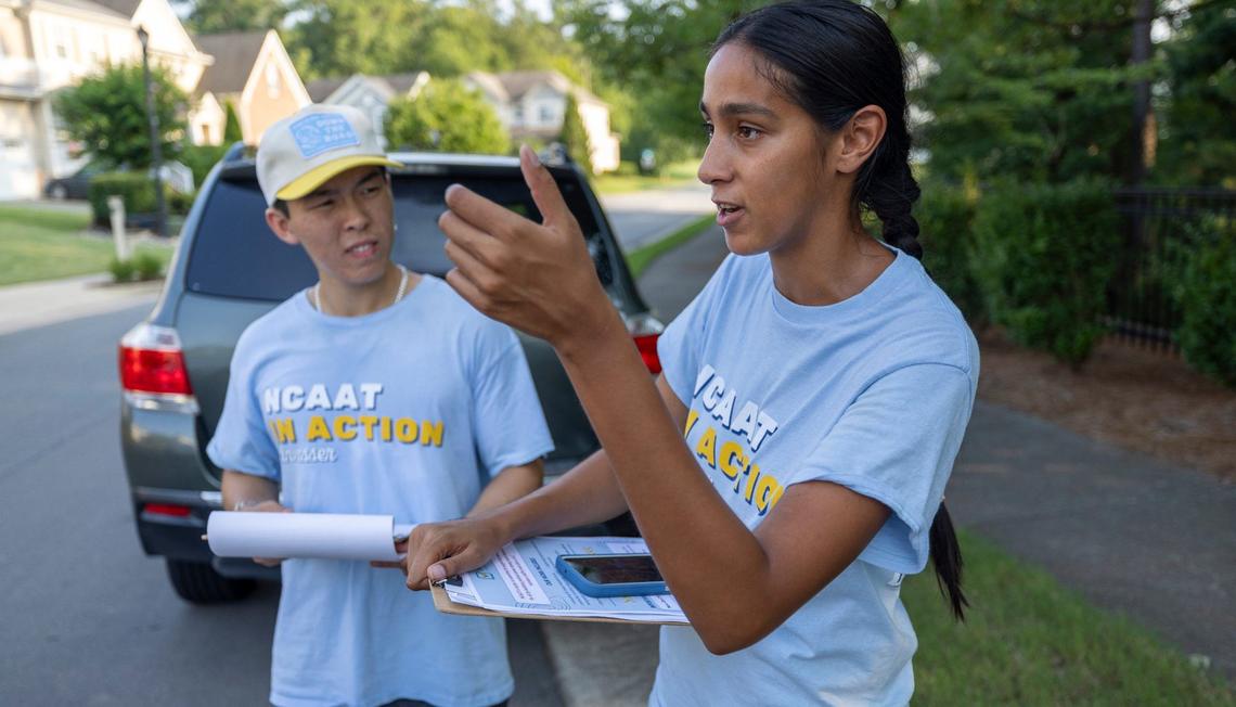 North Carolina Asian Americans Together canvassers William Liu and Annar Parikh plot strategy as they work a neighborhood together on Wednesday, July 31, 2024 in Morrisville, N.C.