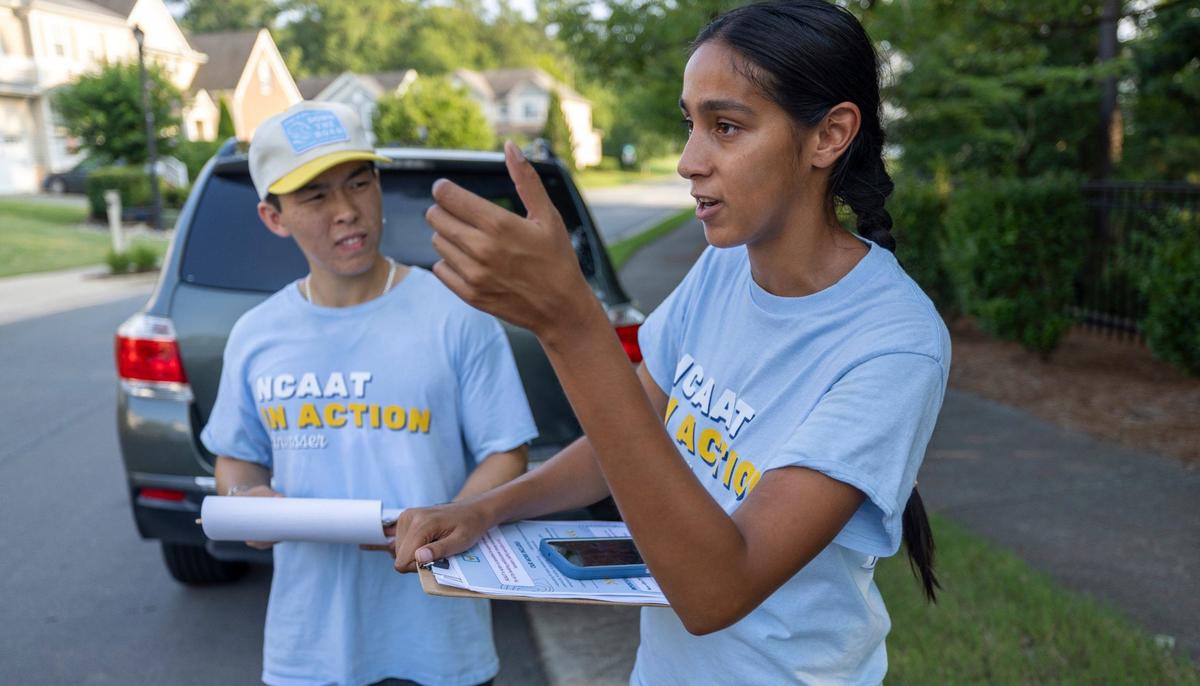 North Carolina Asian Americans Together canvassers William Liu and Annar Parikh plot strategy as they work a neighborhood together on Wednesday, July 31, 2024 in Morrisville, N.C.