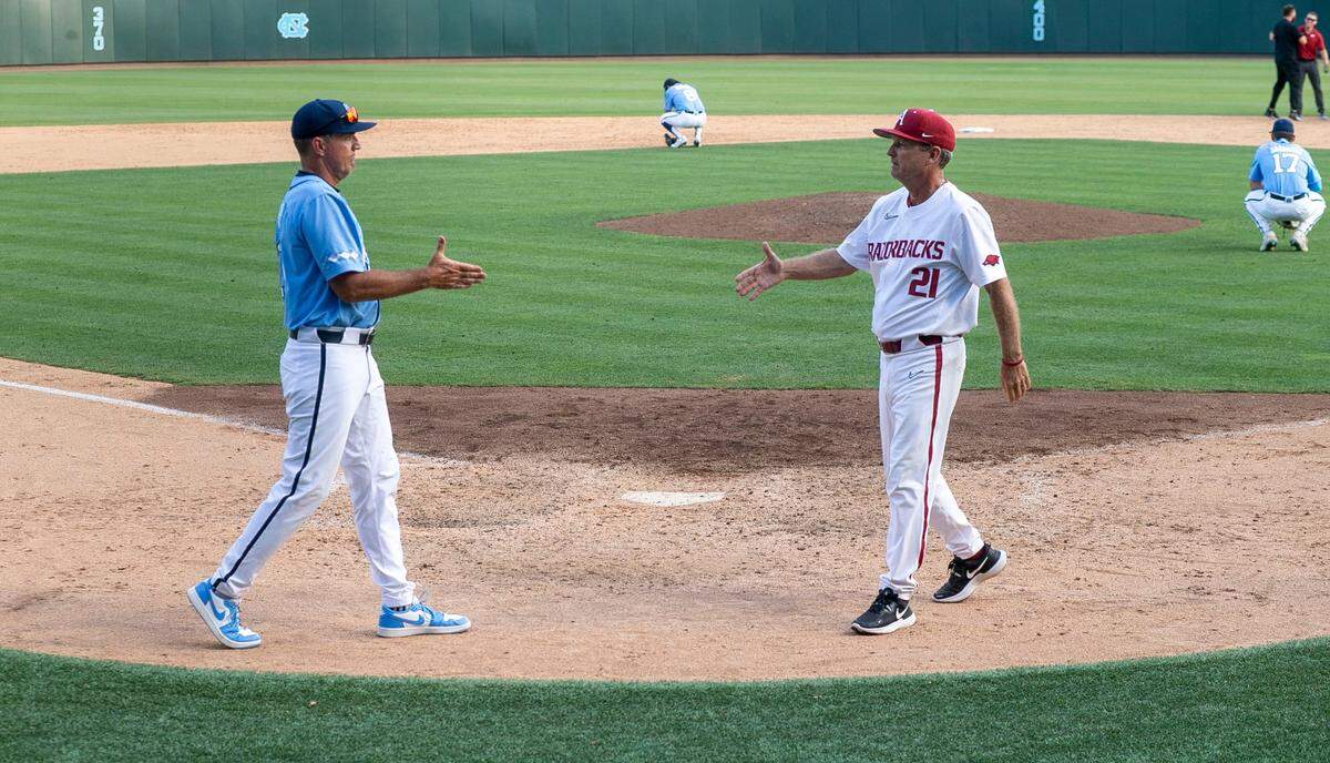 North Carolina coach Scott Forbes congratulates Arkansas head coach Dave Van Horn following the Razorbacks 4-3 victory in the NCAA Super Regional series on Sunday, June 12, 2022 at Boshamer Stadium in Chapel Hill, N.C.