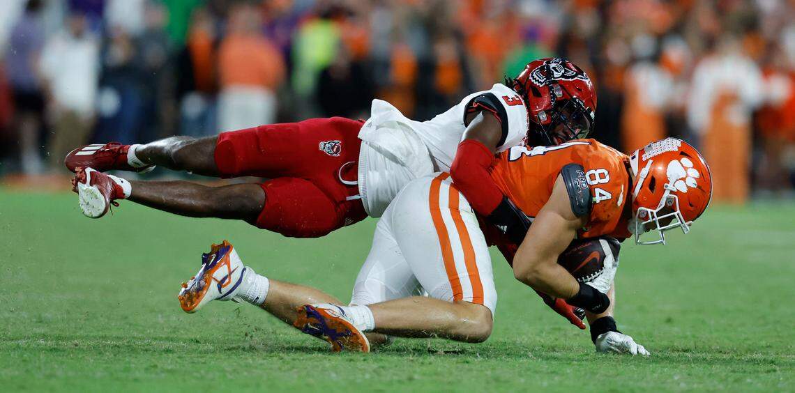 N.C. State cornerback Aydan White (3) tackles Clemson tight end Davis Allen (84) during the second half of Clemson’s 30-20 victory over N.C. State at Memorial Stadium in Clemson, S.C., Saturday, Oct. 1, 2022.