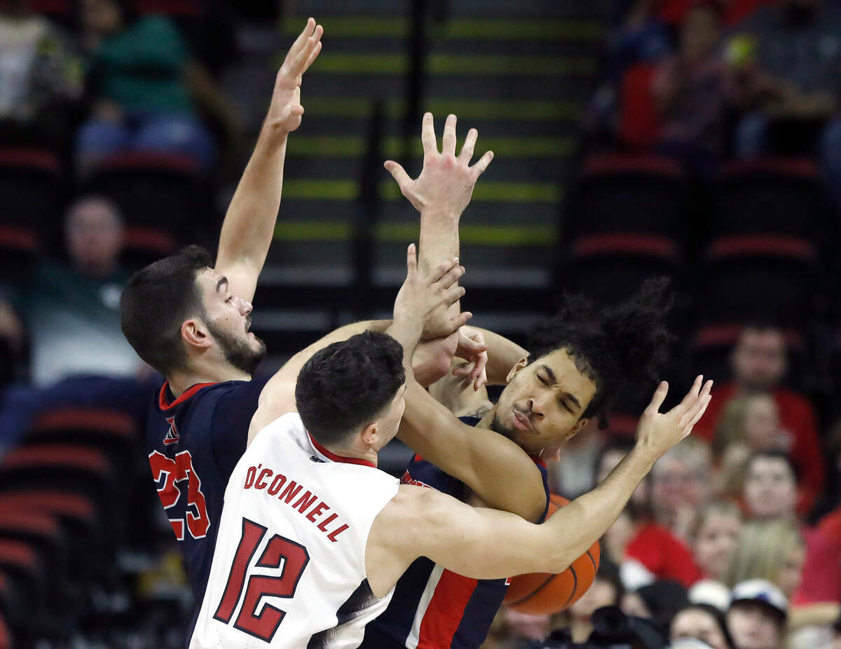 N.C. State’s Michael O’Connell battles for a rebound with Detroit’s Edoardo Del Cadia and Tyree Davis during the second half of the Wolfpack’s 83-66 win on Saturday, Dec. 23, 2023, at PNC Arena in Raleigh, N.C.