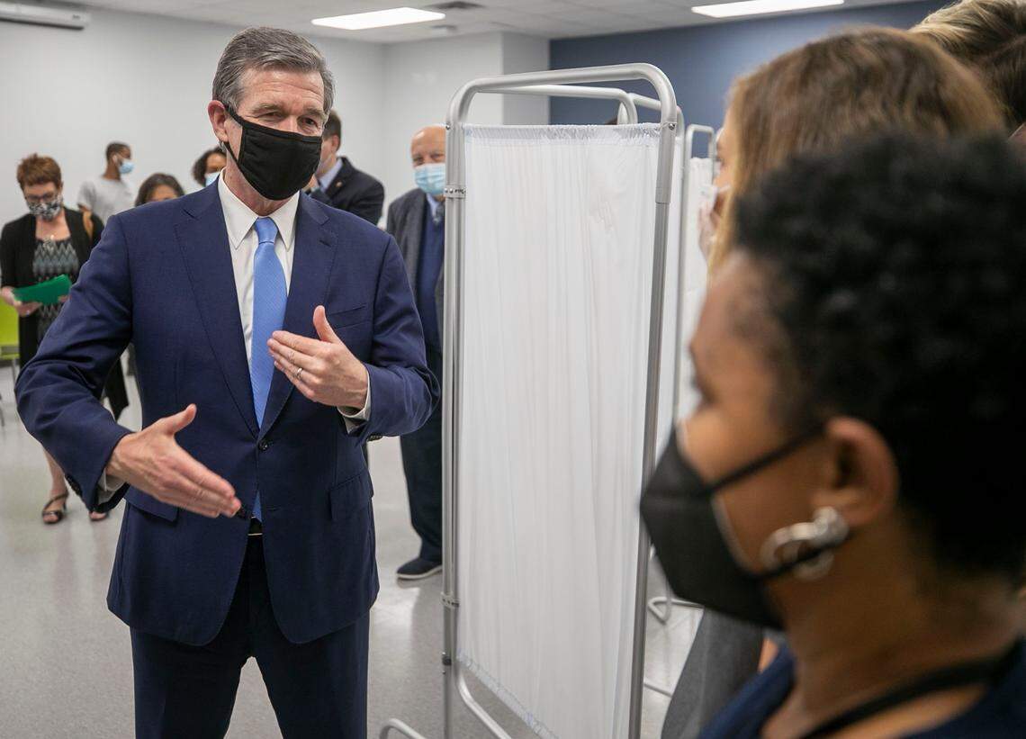 North Carolina Governor Roy Cooper speaks health care workers during a visit to the Wake County Human Services COVID-19 vaccination clinic on Departure Drive on Thursday, May 13, 2021 in Raleigh, N.C. Cooper toured the facility on the first day that COVID-19 vaccinations were available to those aged 12 and up.