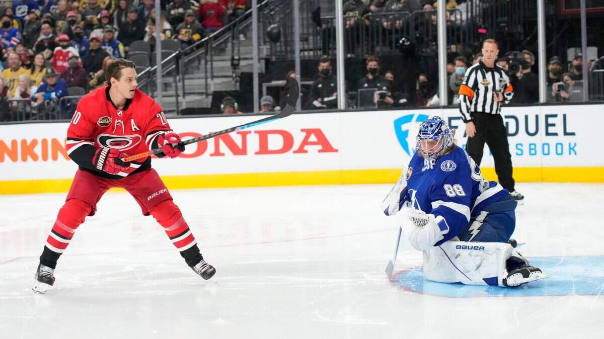 Tampa Bay Lightning goalie Andrei Vasilevskiy, right, and Calorina Hurricanes’ Sebastian Aho participate in the Skills Competition save streak event, part of the NHL All-Star weekend, Friday, Feb. 4, 2022, in Las Vegas. (AP Photo/Rick Scuteri)