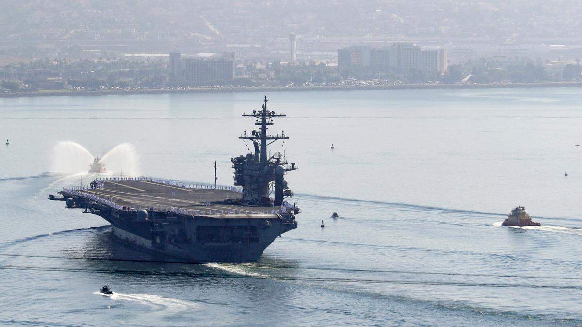 In this July 2020 file photo, the USS Theodore Roosevelt aircraft carrier makes its way into San Diego Bay. The carrier returned after a massive COVID-19 outbreak on board.