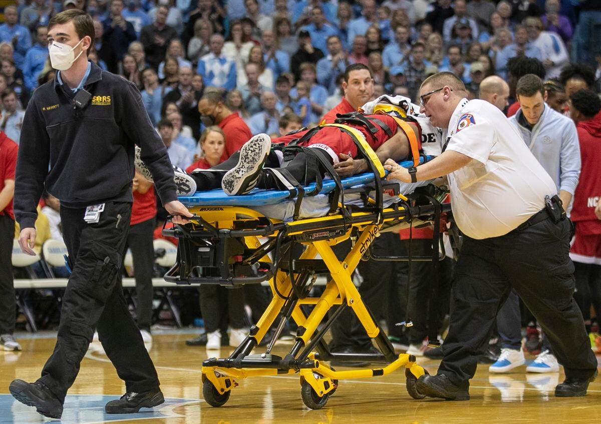 N.C. State’s Terquavion Smith (0) is taken off the court on a stretcher after falling on a hard foul by North Carolina’s Leaky Black in the second half. Black was ejected from the game on Saturday, January 21, 2023 at the Smith Center in Chapel Hill, N.C.