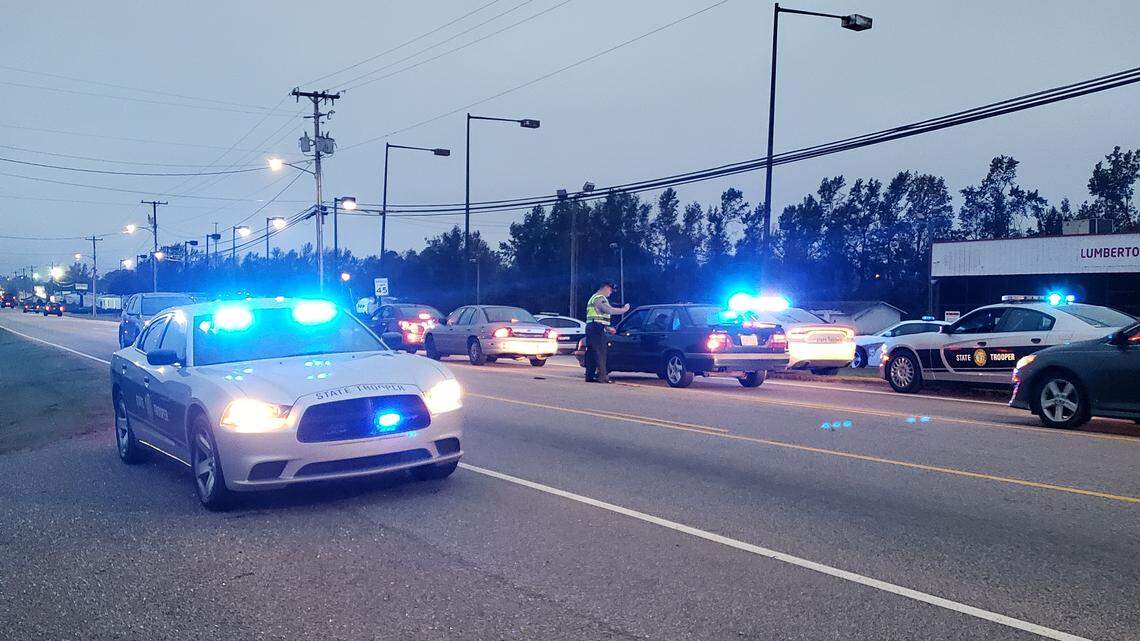 North Carolina Highway Patrol troopers question drivers on Elizabethtown Road in Lumberton on Tuesday morning, hoping to find people who use the road every day and might have information to help authorities find a girl kidnapped from a nearby mobile home park on Monday morning.