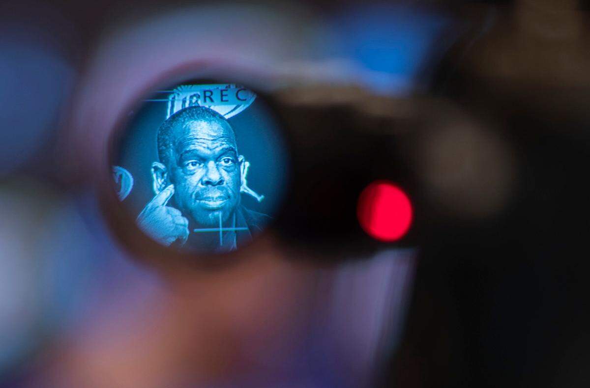 Head basketball coach Hubert Davis is seen listening to a reporters question through the viewfinder of a video camera during a press conference at the Woody Durham Media and Communications Center in Chapel Hill, N.C. on Tuesday, March 29, 2022.