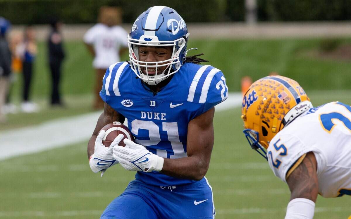 Duke’s Mataeo Durant (21) carries the ball as Pittsburgh’s A.J. Woods (25) approaches during the first half of an NCAA football game in Durham, N.C., Saturday, Nov. 6, 2021.