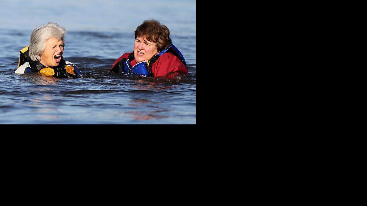 Diane Williford, left, and Jeanne Moyer, right, cringe as they test out their cold water gear during a cold water safety training workshop on Saturday, March 8, 2014 in Durham, N.C. The workshop, hosted by Carolina Kayak Club, was held to help members understand the dangers of cold water and to educate members about rescue techniques.
