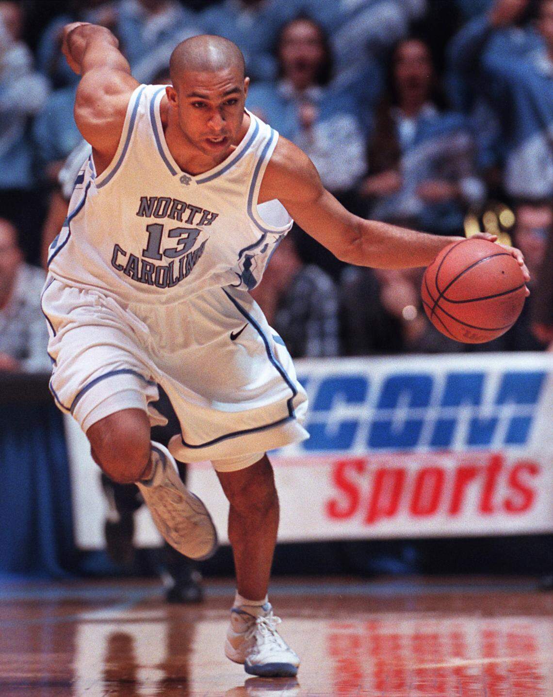 UNC’s Ademola Okulaja pushes the ball up the floor on a fast break during action against NC State in the Smith Center in 1999.