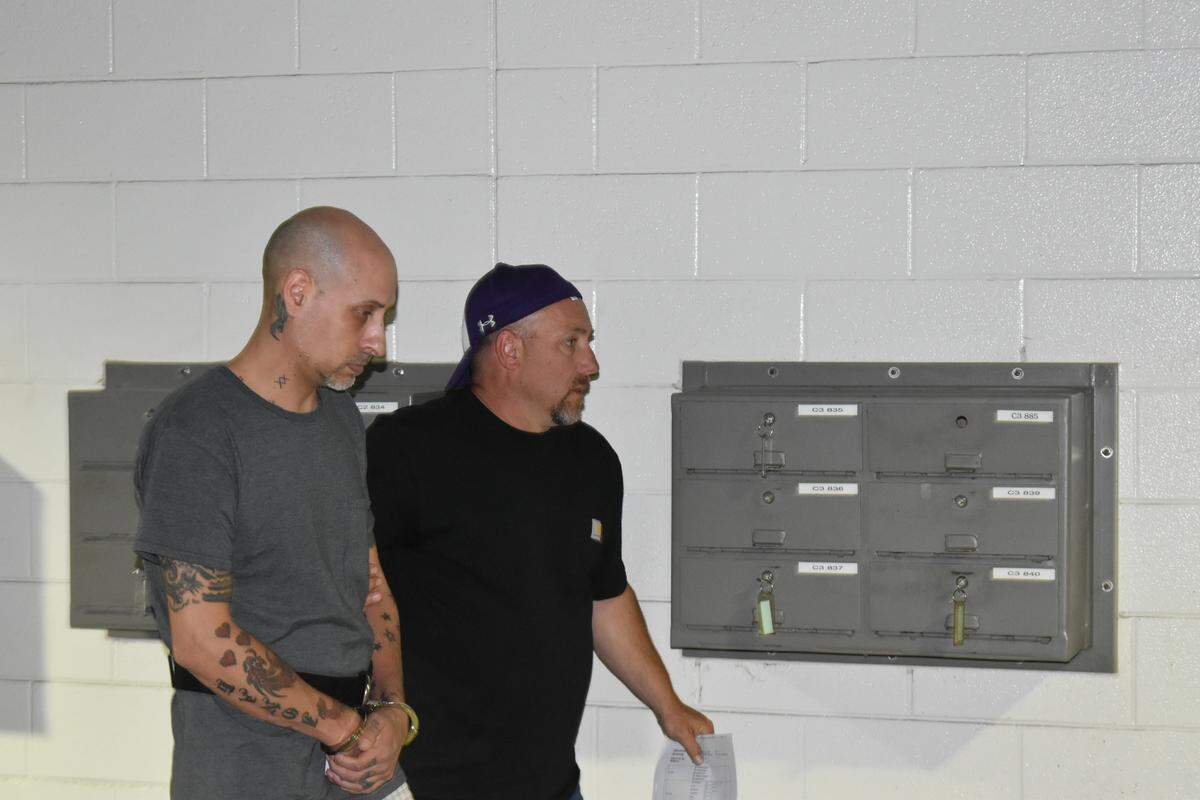 Brian Sluss arrives at Wake County Detention Center the afternoon of May 6. He has been charged with murder in the death of Monica Moynan, his ex-girlfriend.