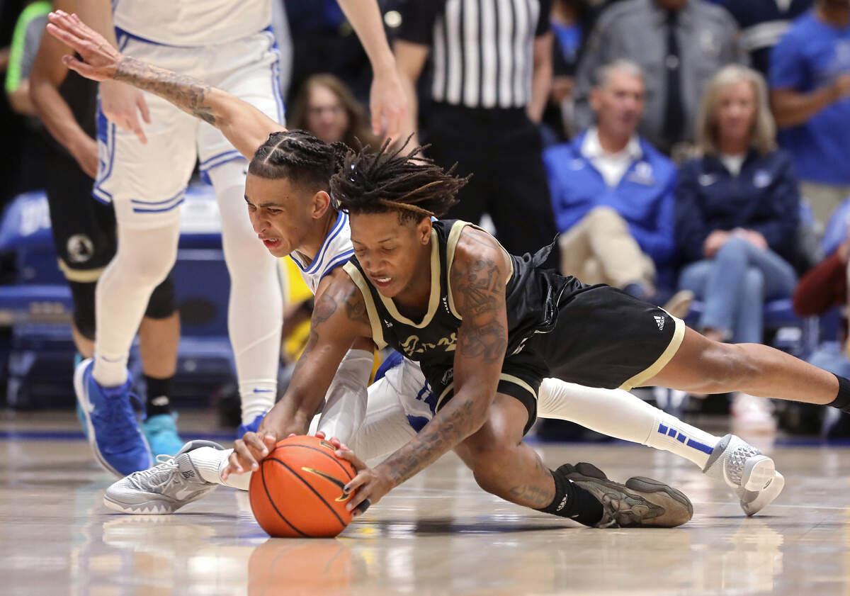 Duke’s Tyrese Proctor and UNC Pembroke’s Dallas Gardner dive after a loose ball during the first half of the Blue Devils’ exhibition game on Wednesday, Nov. 1, 2023, at Cameron Indoor Stadium in Durham, N.C.