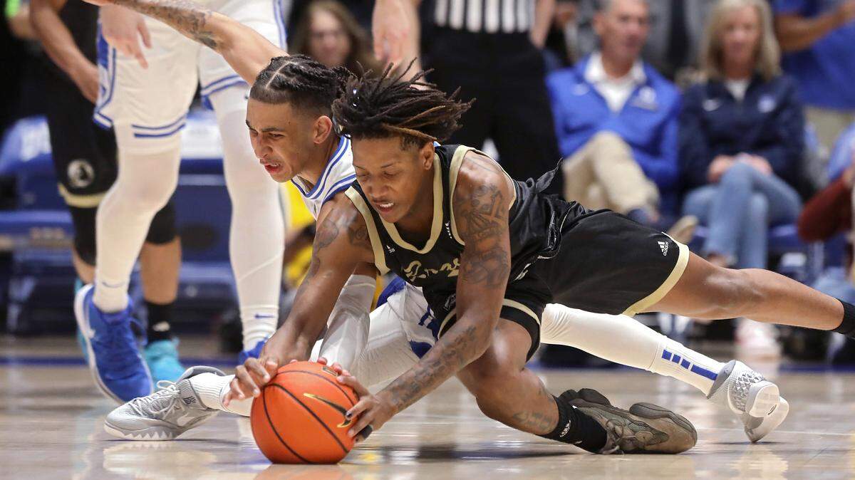 Duke’s Tyrese Proctor and UNC Pembroke’s Dallas Gardner dive after a loose ball during the first half of the Blue Devils’ exhibition game on Wednesday, Nov. 1, 2023, at Cameron Indoor Stadium in Durham, N.C.