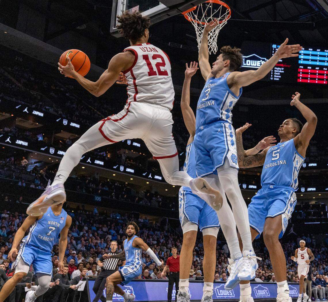 North Carolina’s Zayden High (1), Armando Bacot (5) and Cormac Ryan (3) trap Oklahoma’s Milos Uzan (12) during the first half on Wednesday, December 20, 2023 at the Spectrum Center in Charlotte, N.C.