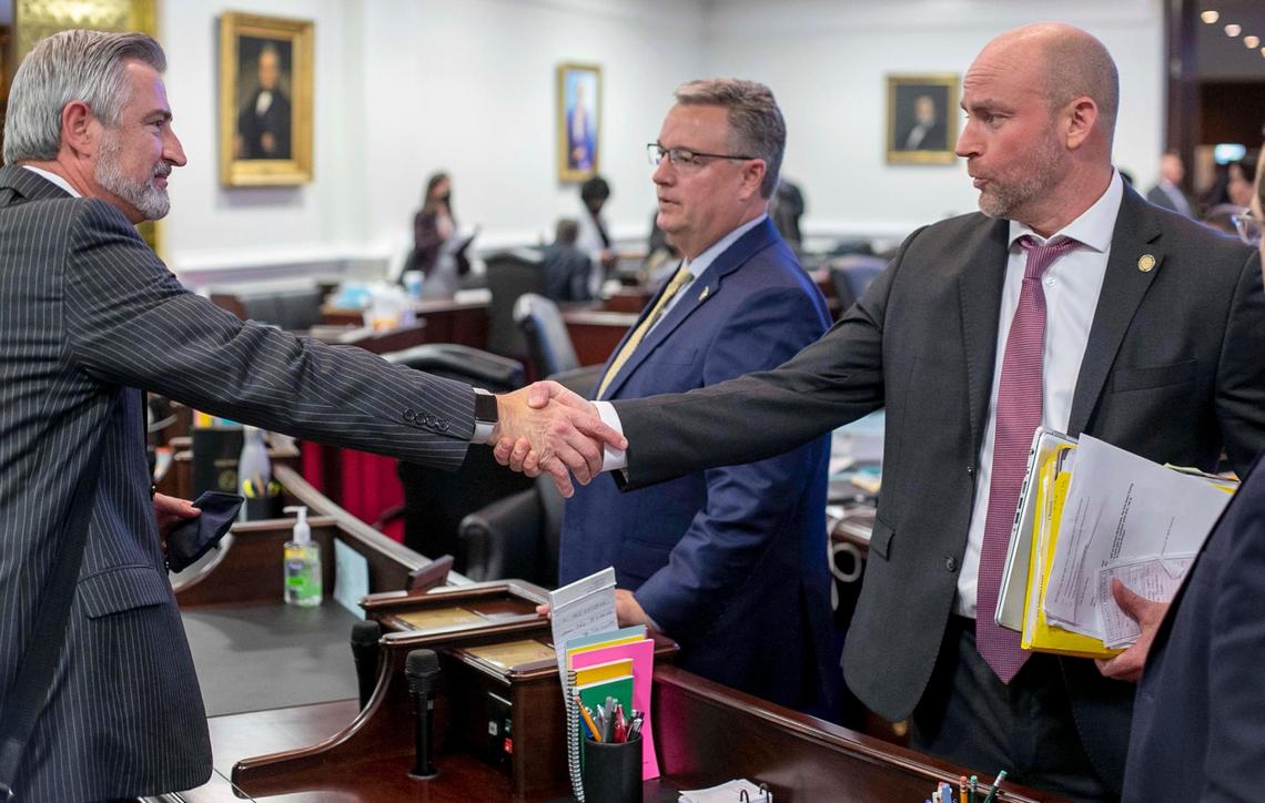 Senator Danny Britt, who represents Columbus and Robeson Counties, shakes hands with Senator Kirk deViere of Cumberland County following the passage of the state budget on Wednesday, November 17, 2021 in Raleigh, N.C.
