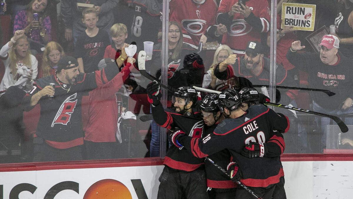 The Hurricanes’ Max Domi (13) is surrounded by teammates Vincent Trocheck (16), Ian Cole (28) and Tuevo Teravainen (86) as they celebrate following Domiís second goal in the second period against Boston on Saturday, May 14, 2022 during game seven of the Stanley Cup first round at PNC Arena in Raleigh, N.C.