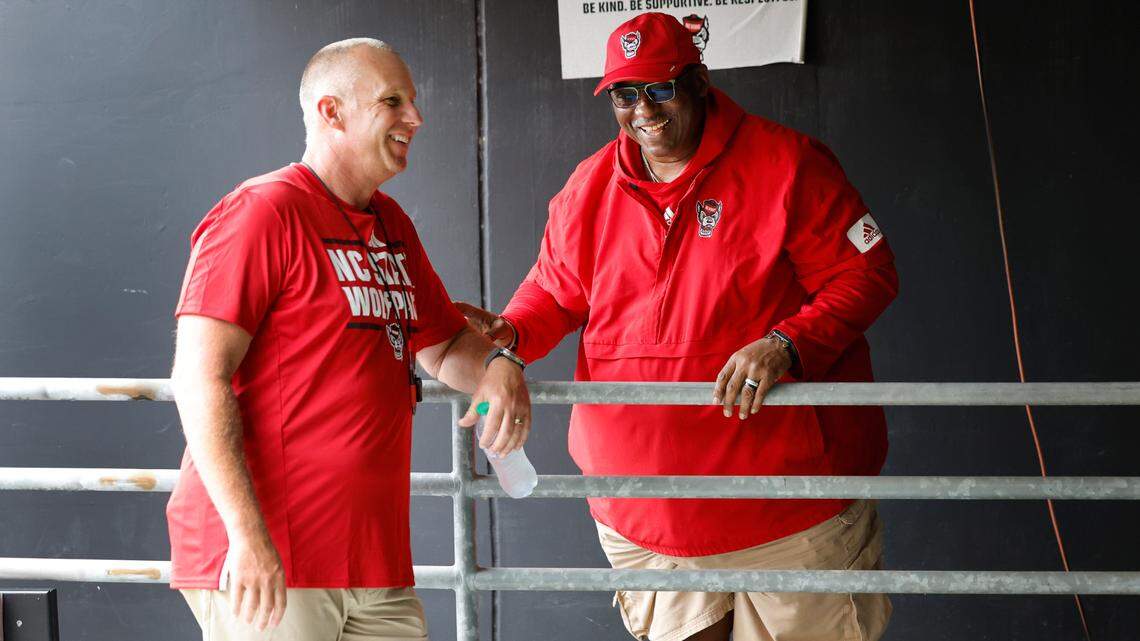N.C. State head football coach Dave Doeren laughs with Ruffin McNeill, special assistant to the head coach, before the Wolfpack’s Victory Day at Carter-Finley Stadium in Raleigh, N.C., Friday, August 2, 2024.