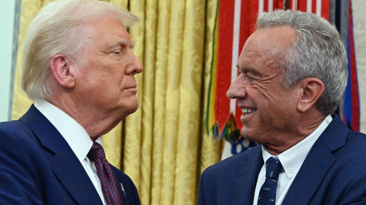 The new U.S. Secretary of Health and Human Services Robert F. Kennedy Jr., shakes hands with President Donald Trump after a swearing in ceremony in the Oval Office of the White House in Washington, D.C., on Feb. 13, 2025.