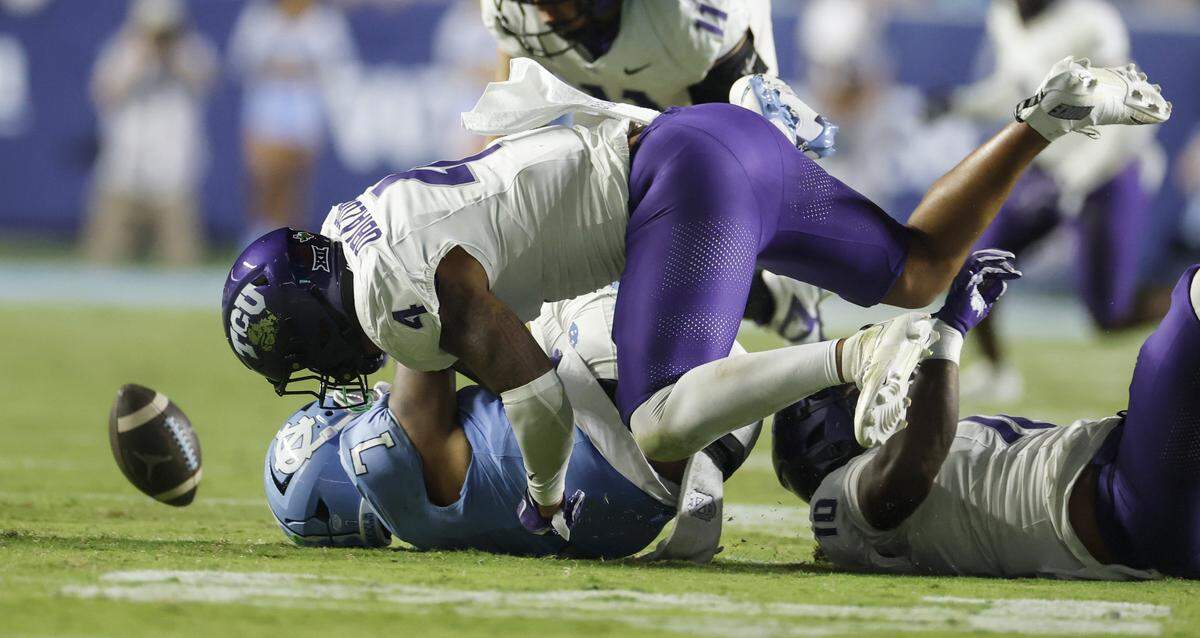 North Carolina quarterback Gio Lopez (7) fumbles the ball while being sacked by TCU linebacker Namdi Obiazor (4) during the second half of UNC’s game against TCU at Kenan Stadium in Chapel Hill, N.C., Monday, Sept. 1, 2025. Lopez was injured on the play.