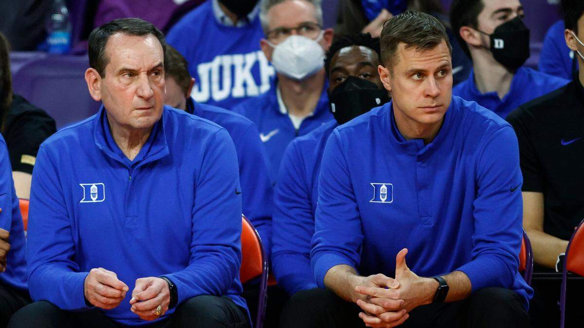 Duke coach Mike Krzyzewski, left, and assistant coach Jon Scheyer watch as Duke plays Clemson during the first half of an NCAA college basketball game in Clemson, S.C., Thursday, Feb. 10, 2022. (AP Photo/Nell Redmond)