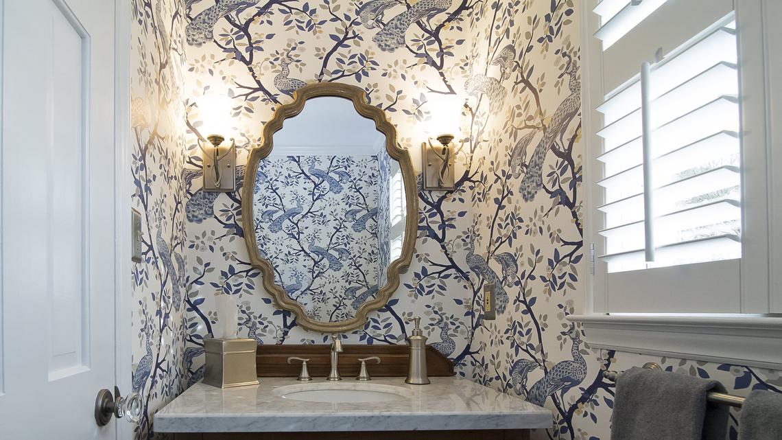 In this powder room, you have just entered a romantic garden.  Mixing silver and gold in this bathroom keeps it interesting and not dated.  The paper is from Dwell Studio by York. 