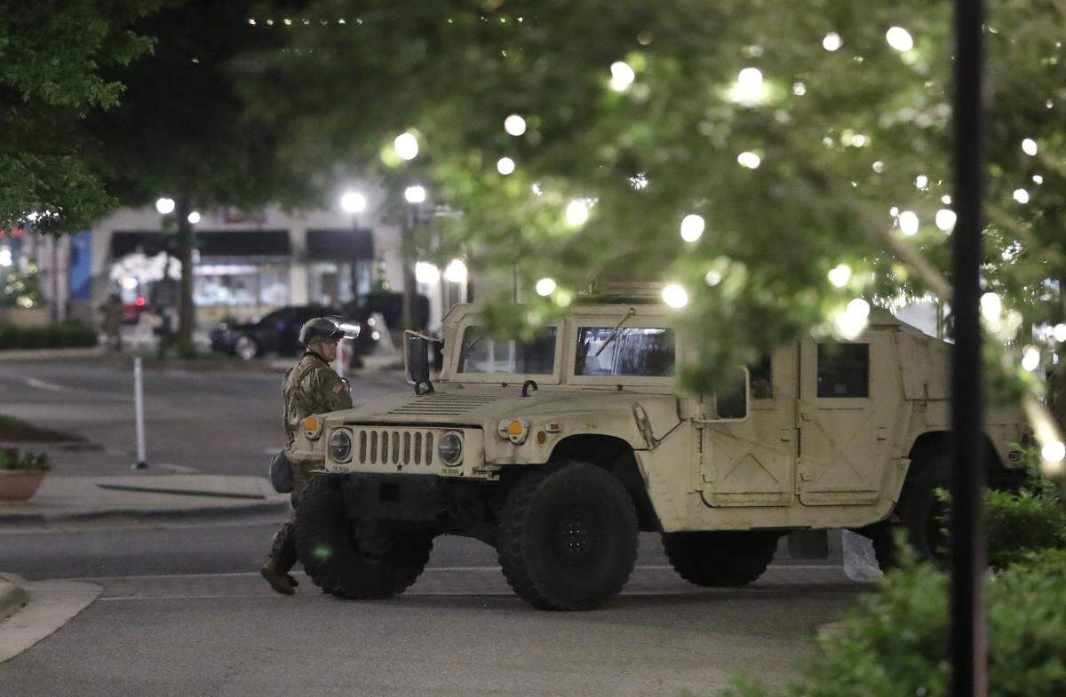 Members of the North Carolina National Guard stand guard at North Hills Mall early Monday morning, June 1, 2020.
