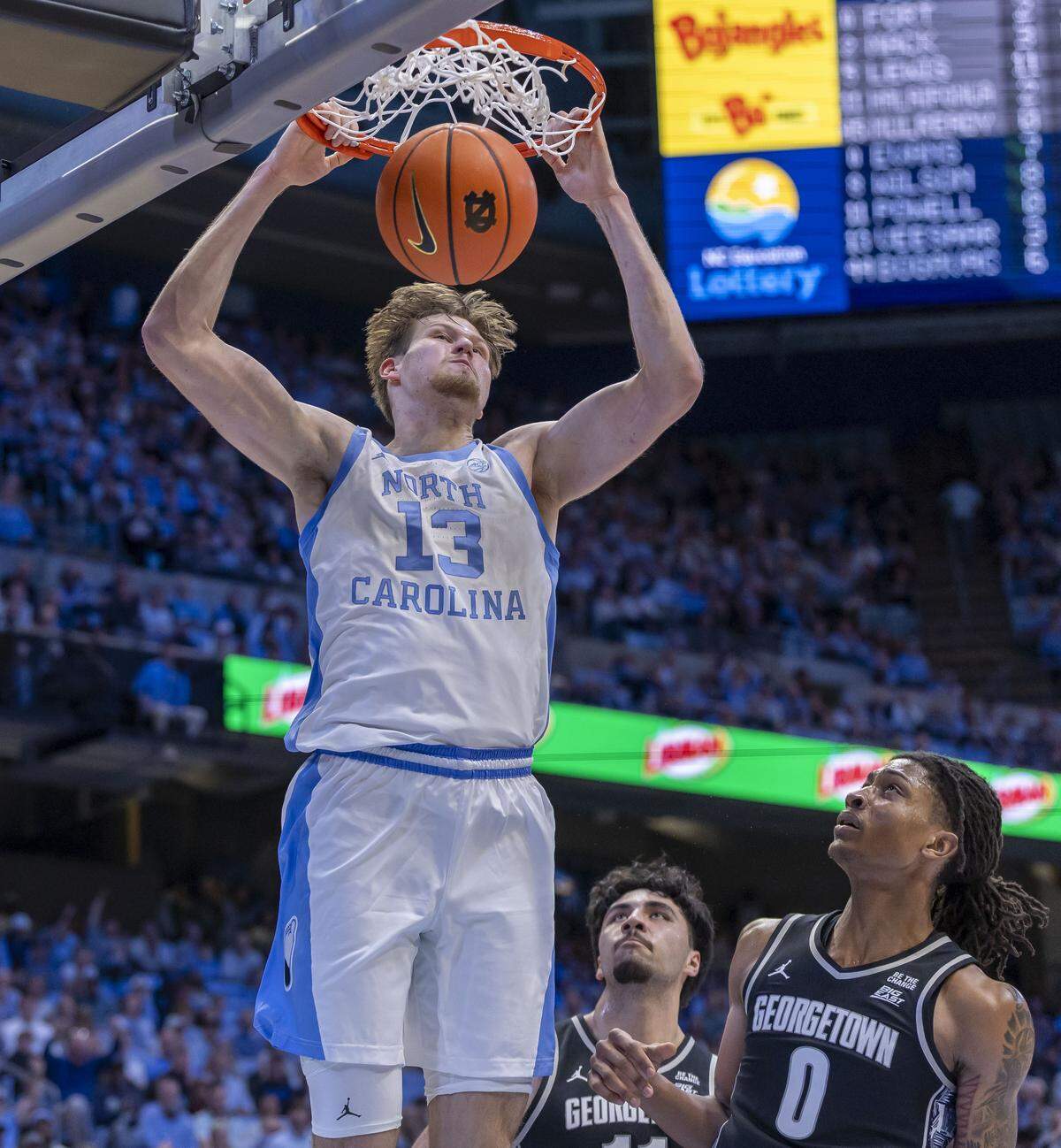 North Carolina center Henri Veesaar (13) breaks to the basket for a dunk against Georgetown forward Jayden Fort (0) in the first half on Sunday, December 7, 2025 at the Smith Center in Chapel Hill, N.