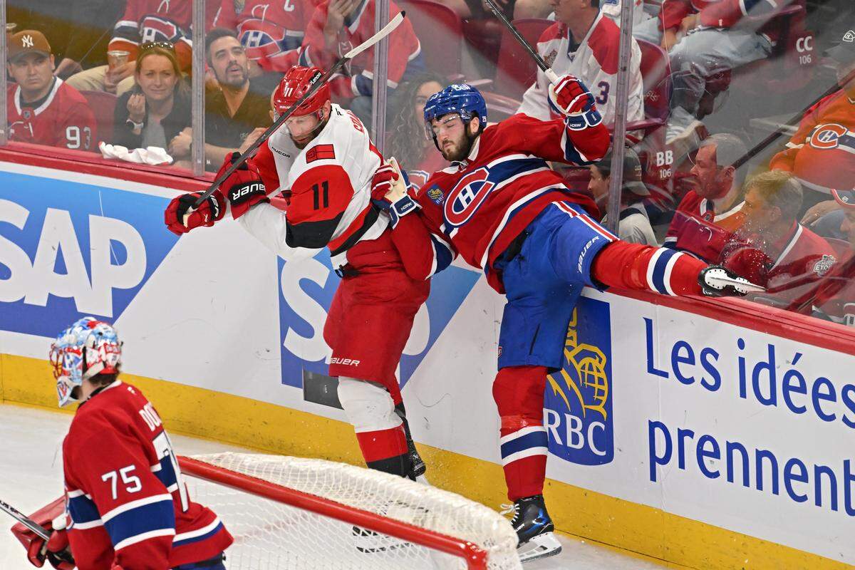 Jordan Staal #11 of the Carolina Hurricanes and Noah Dobson #53 of the Montreal Canadiens collide during the third period in Game Four of the Eastern Conference Final of the 2026 Stanley Cup Playoffs at Bell Centre on May 27, 2026 in Montreal, Quebec, Canada. 