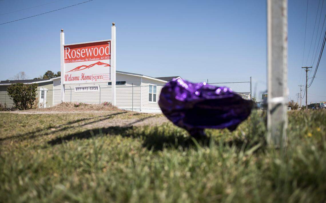 A purple ballon tied to a stop sign in honor of Hania Aguilar floats in the wind outside the Rosewood Mobile Home Park where she lived on March 29, 2019, eight days after she would have had her 14th birthday.