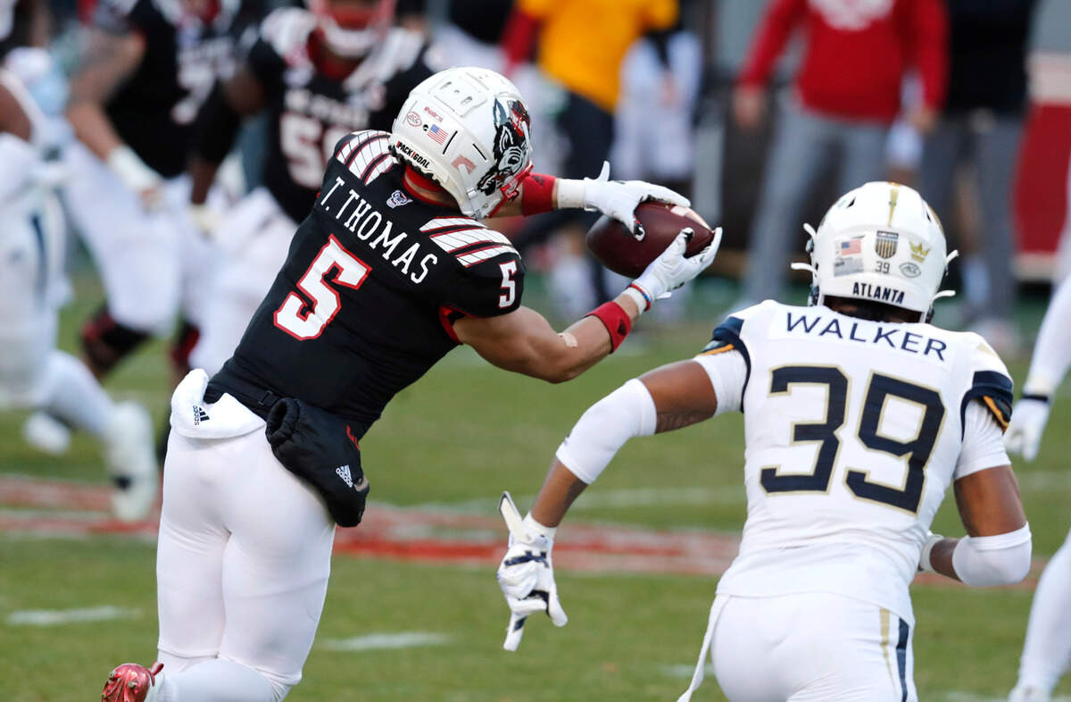 N.C. State wide receiver Thayer Thomas (5) pulls in a reception during the first half of N.C. State’s game against Georgia Tech at Carter-Finley Stadium in Raleigh, N.C., Saturday, Dec. 5, 2020.