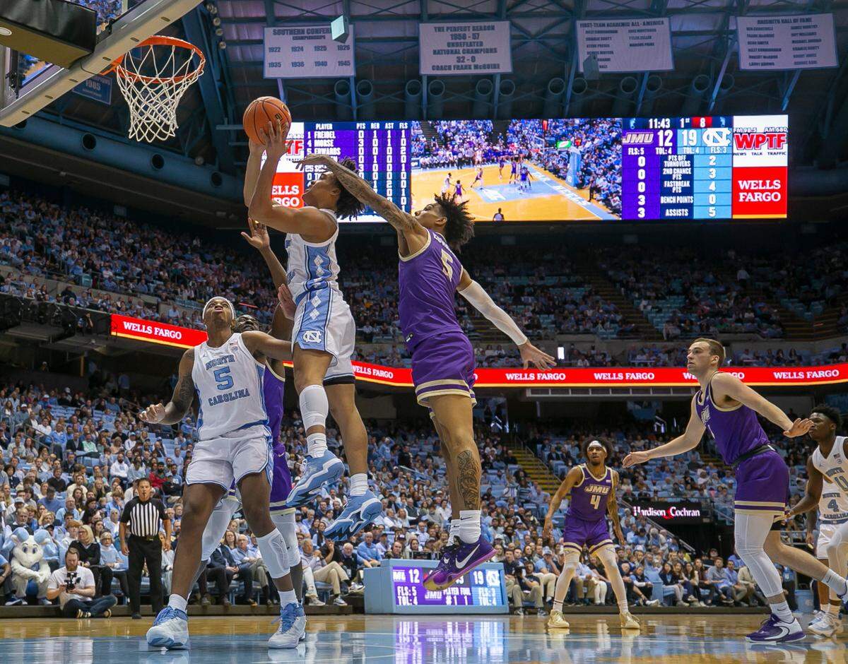 James Madison’s Terrence Edwards (5) defends North Carolina’s Seth Trimble (0) in the first half on Sunday, November 20, 2022 at the Smith Center in Chapel Hill, N.C.