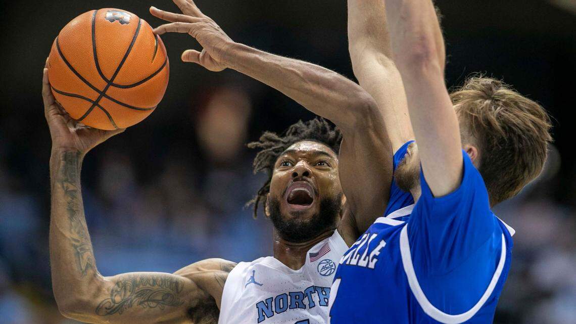 North Carolina’s Leaky Black (1) drives to the basket against UNC-Asheville’s Drew Pember (4) during the second half on Tuesday, November 23, 2021 at the Smith Center in Chapel Hill, N.C.