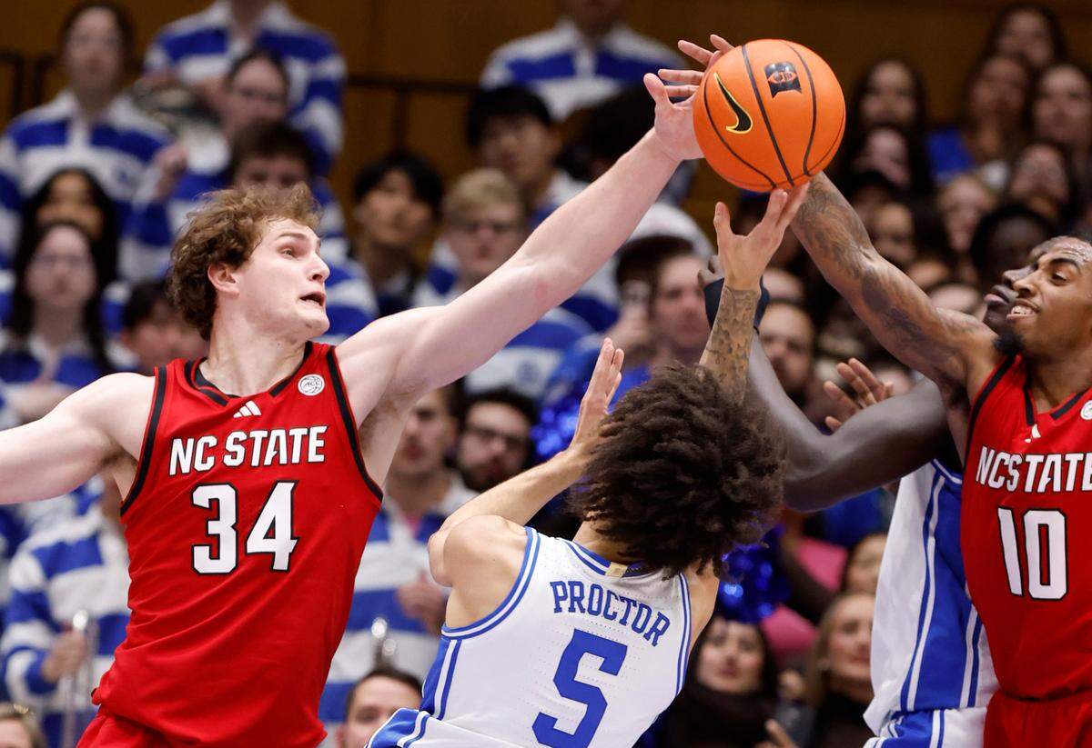 N.C. State’s Ben Middlebrooks (34) and Marcus Hill (10) defend Duke’s Tyrese Proctor (5) during the first half of Duke’s game against N.C. State at Cameron Indoor Stadium in Durham, N.C., Monday, Jan. 27, 2025.